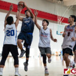 FBLG Hawks Ashle runs up the middle for a shot at the basket while St. Paul Warriors Jaden Santos contests. (Photo by Michael Blas)
