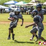 Guam Raiders Ethan Guerrero looks to get past the Island Broncos defense. (photo by Bout It Productions)