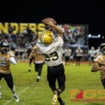 Tiyan Titan's Kio Kaminanga completes the catch near the JFK Islander's sideline. (Photo by Michael Blas)