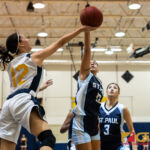 St. Paul Warriors Keiani Pangelinan gets a hand on the ball, blocking Guam High Panthers Torie Aguon. (Photo by Michael Blas)