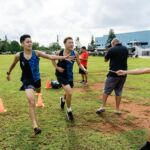 St. Paul Warrior Brandon Miranda finished in first place with a time of 18:07.00 and teammate Kanta Yamazaki trails right behind with a time of 18:08.00. (Photo by Michael Blas)