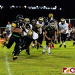JFK Islander Jacobe Quinata sprints past the Titan defensive line for the first down. (Photo by Michael Blas)