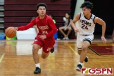 Okkodo Bulldog Kobe Santos brings the ball down court while FD Friar Blaise Ada defends. (Photo by Michael Blas)