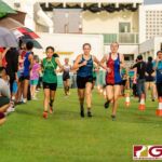 Freshmen runners Trixia Nierva, left, Hannah Zura, center, and Jordan Baden, right, lead the girls race midway into the course. (Photo by Michael Blas)