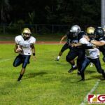 Tiyan Titan Christopher Cowart runs towards open space for a short gain on the play. (Photo by Michael Blas)
