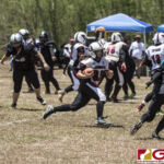 Team Legacy's Jalana Garcia looks to get past the last defender before taking it to the end zone. (photo by Bout It Productions)