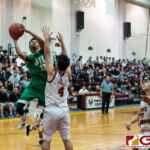 JFK Islanders Jerry Ngraremiang gets up for two points while FD Friars Raynard Castro contests. (Photo by Michael Blas)