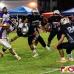 GW Gecko Noah Quichocho carries the ball on a kick return while Sanchez Shark Jayton Penaflor closes in for the tackle. (Photo by Michael Blas)