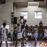San Vicente Braves Truman Howard finds himself shooting between two St. John Knights defenders. (photo by Bout It Productions)