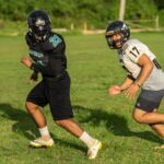 The Silver Mustangs Gabe Stanley, left, and Kamerin Toves, right, run a passing route at practice. (Photo by Michael Blas)