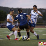 Academy Cougars Chloe Salas attempts to get past two defending Panthers. (photo by Bout It Productions)