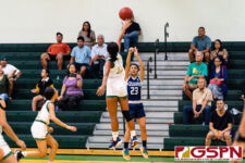 Academy Cougar Oriana Sevilla fires a three pointer while JFK Islander's Jada Han contests. (Photo by Michael Blas)