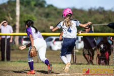 Academy Cougars Bella Muna is safe at base after an overthrown ball. ( photo by Bout It Productions )
