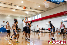 GW Gecko Gevon Fernandez lets a floater go while JFK Islander Vorel Cruz contests. (Photo by Michael Blas)