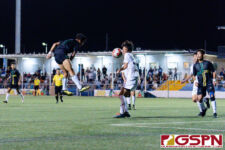 Harvest Eagle Seungchan Lee successfully defends a header from JFK Islander Justin Cruz. (Photo by Michael Blas)