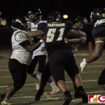 The JFK Islanders offensive line attempt to hold back Guam High Panthers Avery Gamboa from getting to their quarterback. (photo by Bout It Productions)