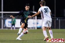 JFK Islander Christian Kido makes an attempt to get through Harvest Eagle defender Taka Ward. (Photo by Michael Blas)