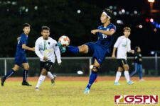 Harvest Eagle James Lee connects with the ball in mid field early in the game. (Photo by Michael Blas)