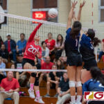 St. John's Knights Hallie Wigsten connects with a spike towards AOLG Cougars Laressa Halladay and Isabella Bargfrede. (Photo by Michael Blas)
