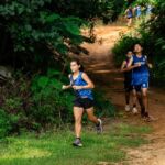 St. Paul Warrior Shakeera Esma pulls away from the rest of the girls early on in the race. (Photo by Michael Blas)