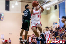 Okkodo Bulldog Jon Lorena gets up past JFK Islander Robert Satauo for two points. (Photo by Michael Blas)