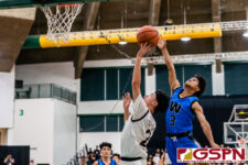FD Friar Colin Santiago gets up for a shot as St. Paul Warrior Jon Sevilla attempts to block. (Photo by Michael Blas)