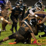 JFK Islanders defense grab a hold of GW Geckos Jose San Miguel as he drives the ball forward. (Photo by Michael Blas)