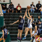 Academy Cougars Mia San Nicolas gets a block on St. Paul Warriors Monica Giger. (Photo by Michael Blas)