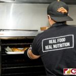 Boka Box Nutrition Professional/Owner Jesse E. Rosario prepares a set of meals during their daily meal prep. (Photo by Michael Blas)