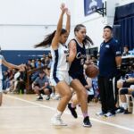 Mia San Nicolas maintains control of the ball as St. Paul Warriors Keiani Pangelinan keeps pressure. (Photo by Michael Blas)