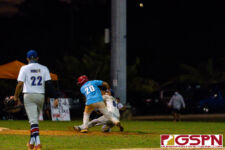 GW Gecko Ashton Tedtaotao gets shoved by ND Royal Brandon Tuguero on a run to third base. (Photo by Michael Blas)