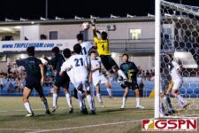 Harvest Eagle Goalkeeper Marcus Del Rosario makes a critical save on a JFK cross in extra time. (Photo by Michael Blas)