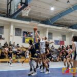Academy Cougars Mia San Nicolas and Guam High Panthers Jodyn Palomares leap up to grab the rebound. (Photo by Michael Blas)