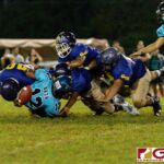 The GW Gecko Noah Quichocho knocks the ball loose off of Southern Dolphin Conan Baza for the defense to recover. (Photo by Michael Blas)