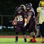 Father Duenas Friars Michael Castro is congratulated after running the ball in for a touchdown. (Photo by Michael Blas)
