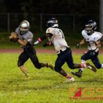 Simon Sanchez Sharks Jayton Penaflor tries to gain yardage but Guam High Panthers Sincere Powell pressures him. (Photo by Michael Blas)