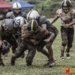 Tamuning Steelers Jason Jay Suda powers through the Steelers defense after the catch. (photo by Bout It Productions)