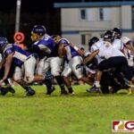 GW Gecko RB Aiden Aguon powers up the middle through the JFK defensive line. (Photo by Michael Blas)