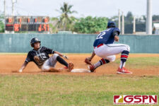 New Zealand's Branson Matsumoto slides into third as Guam's Franklin Ninete reaches for a tag out. (Photo by Michael Blas)