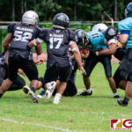 Southern Dolphin Ethaniel Escuadra keeps the ball and goes straight up the middle for a short gain on the play. (Photo by Michael Blas)