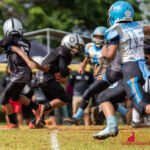 Raiders QB Peter Concepcion hands off to Peter Mesa on a run play late in the first quarter. (Photo by Michael Blas)
