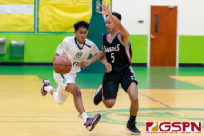 JFK Islander Rodson Simina brings the ball down court in the second quarter. (Photo by Michael Blas)