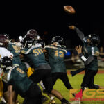 JFK Islander's QB Andrew Perez launches a pass behind his strong offensive line. (Photo By Michael Blas)