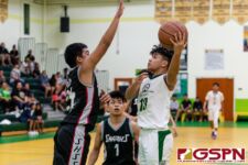 JFK Islander Amram Yobei goes in for a layup while Sanchez Shark Isaiah Malig contests. (Photo by Michael Blas)