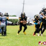 Steelers Jerrmiah Martinez finds the open hole in the Broncos defensive line. (Photo by Michael Blas)
