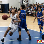 St. Paul Warriors Brandon Soulik breezes past Bishops defense for a shot in the paint. (Photo by Michael Blas)