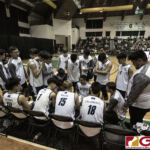 Harvest Eagles players go over plays with their coach during timeout. (photo by Bout It Productions)