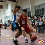 St. John's Knights E. Yu dribbles the ball in for a shot at the bucket while St. Paul Warriors Aiken keeps the pressure on. (Photo by Michael Blas)