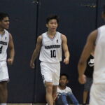 The team rallies behind Hyato Tsuji as he converts a big layup after a steal. (photo by Robert Balajadia)