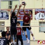 Okkodo Bulldogs Alvin Aromin connects on the spike while Warriors Jonathan Hotelling looks to block. (Photo by Michael Blas)